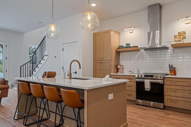 kitchen with stainless steel range with electric stovetop, a sink, open shelves, and extractor fan