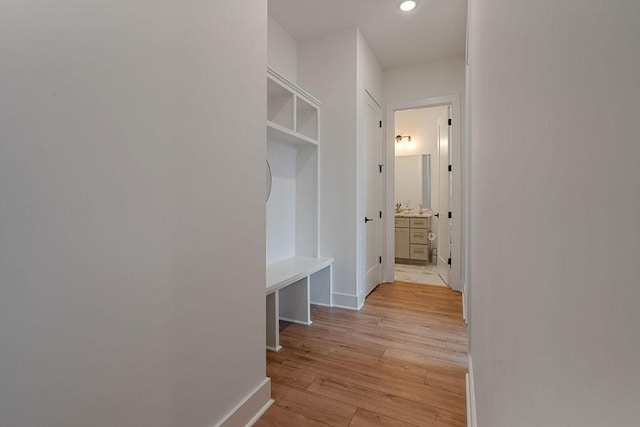 mudroom featuring light wood-type flooring, baseboards, and recessed lighting