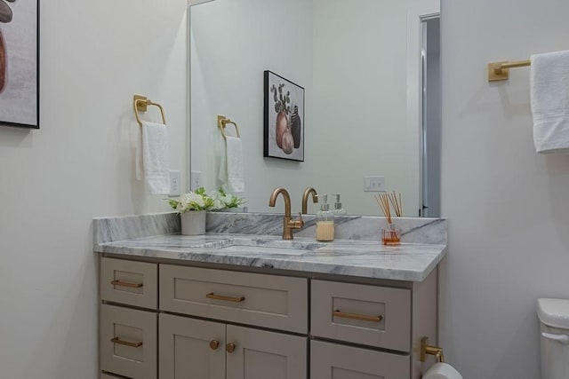 bathroom with toilet and vanity