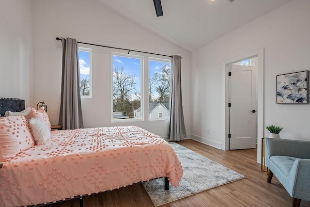 bedroom featuring lofted ceiling, ceiling fan, baseboards, and wood finished floors