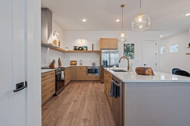 kitchen with open shelves, stainless steel appliances, light countertops, a sink, and wall chimney range hood