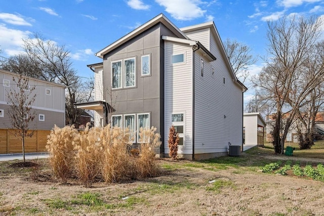 back of house with central AC unit