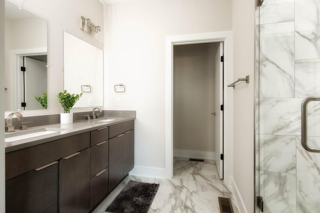 full bath featuring marble finish floor, a sink, a marble finish shower, and baseboards