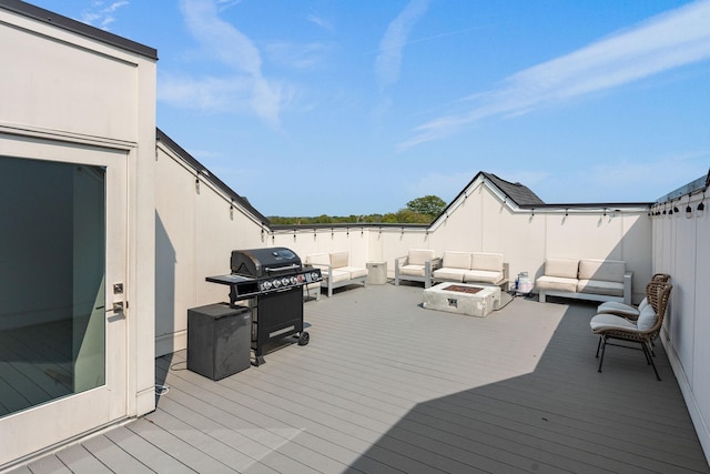 deck featuring an outdoor living space with a fire pit and a grill