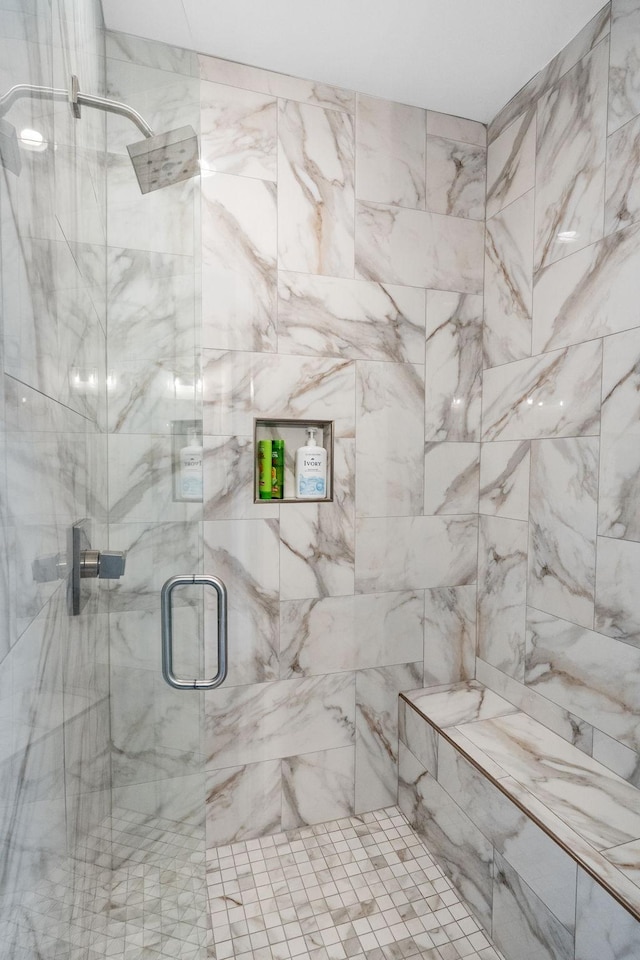 full bath with a marble finish shower