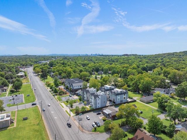 drone / aerial view featuring a wooded view