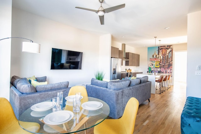 living area featuring ceiling fan and light wood-style floors