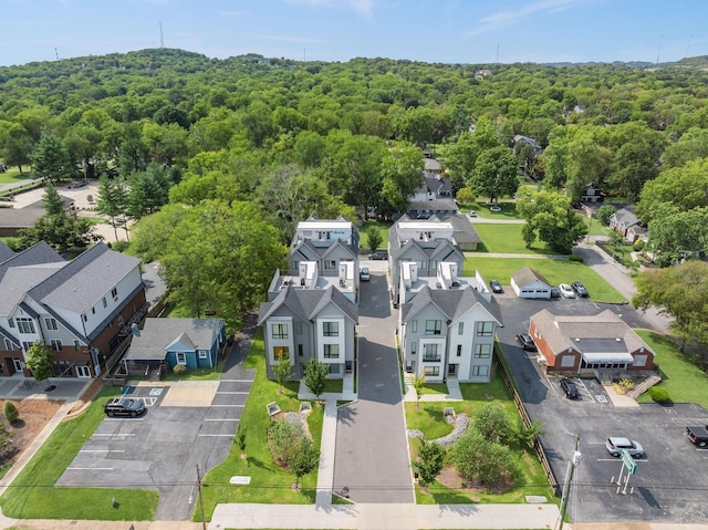 birds eye view of property with a residential view and a wooded view