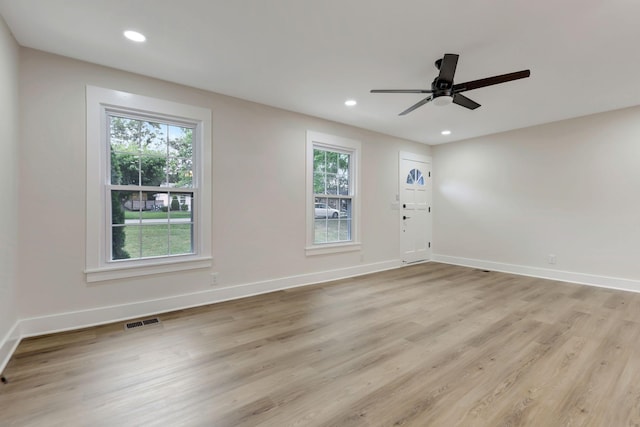 empty room with recessed lighting, light wood-type flooring, visible vents, and baseboards