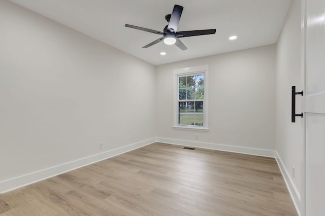 spare room featuring a ceiling fan, light wood-type flooring, baseboards, and recessed lighting