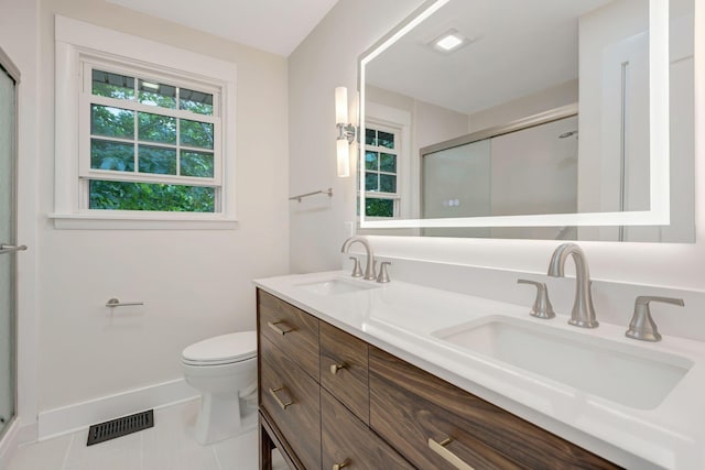 bathroom with a stall shower, a sink, and visible vents