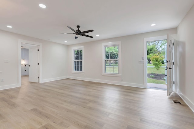 unfurnished living room featuring a wealth of natural light, light wood-type flooring, visible vents, and recessed lighting