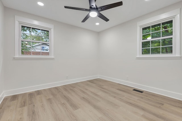 unfurnished room with baseboards, recessed lighting, visible vents, and a healthy amount of sunlight