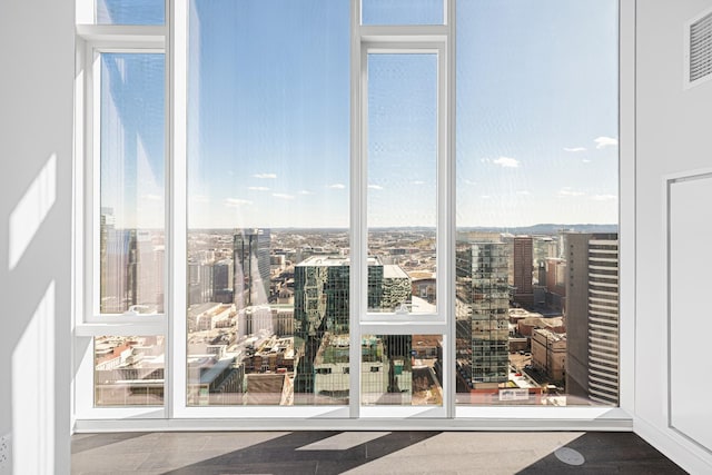 doorway to outside with a wall of windows and a city view