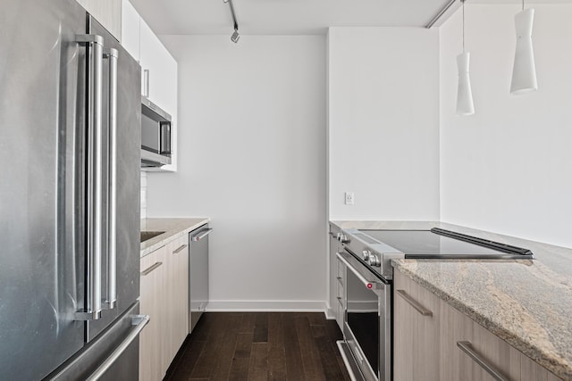 kitchen with appliances with stainless steel finishes, light stone countertops, dark wood-type flooring, and modern cabinets