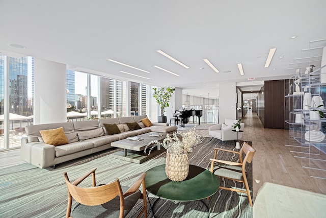 living area with wood finished floors and floor to ceiling windows