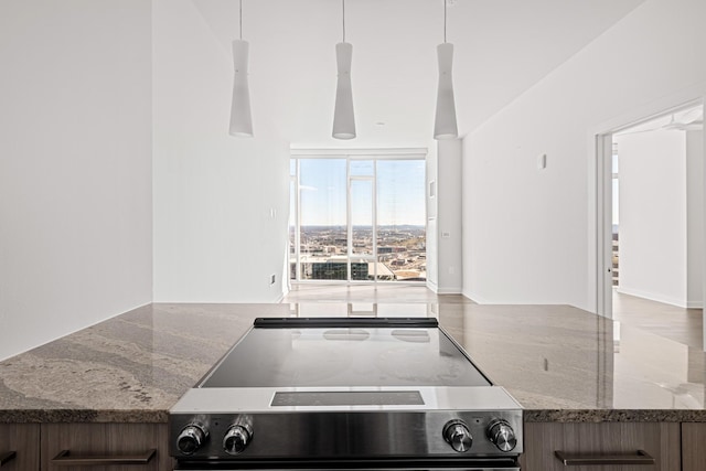 kitchen featuring a wall of windows, range with electric cooktop, and stone counters