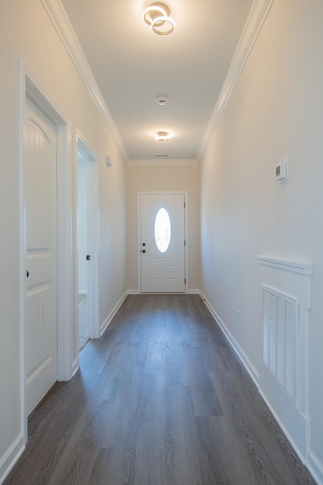 doorway featuring visible vents, crown molding, baseboards, and dark wood-style flooring