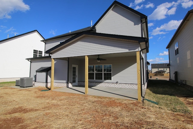 rear view of house featuring a patio area, a yard, central AC, and a ceiling fan