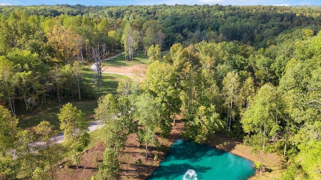 aerial view featuring a forest view and a water view