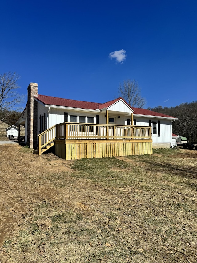 manufactured / mobile home featuring a deck and a chimney