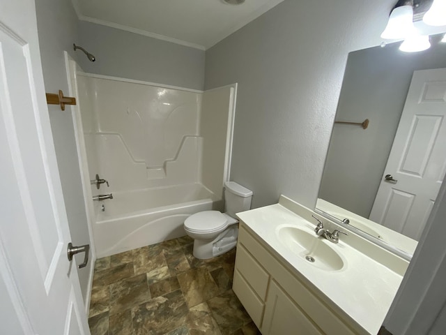 bathroom featuring toilet, stone finish floor, crown molding, vanity, and washtub / shower combination