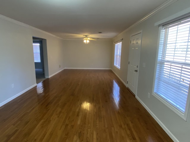 interior space featuring a ceiling fan, dark wood finished floors, crown molding, and baseboards