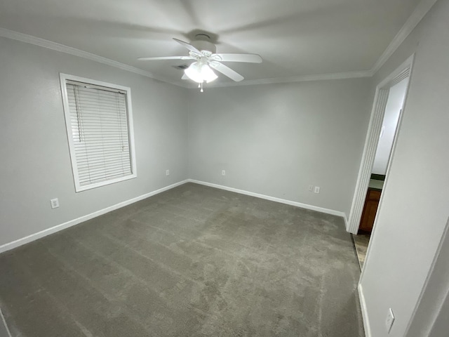 unfurnished room featuring baseboards, dark colored carpet, ceiling fan, and crown molding