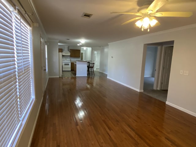 unfurnished living room with ceiling fan, baseboards, dark wood-style flooring, and crown molding