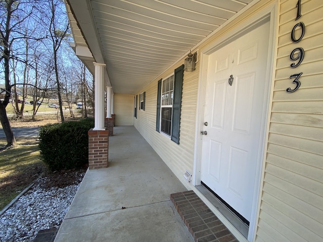 doorway to property featuring covered porch