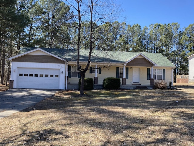 ranch-style home featuring a garage, driveway, and a porch