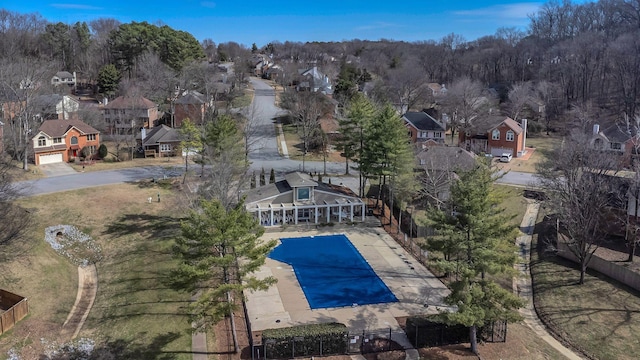 view of swimming pool featuring a residential view and fence