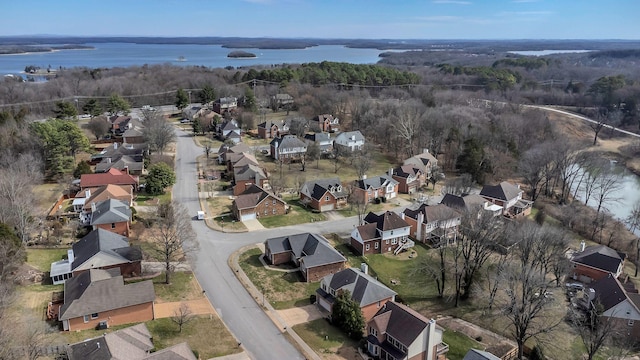 aerial view featuring a residential view, a water view, and a view of trees