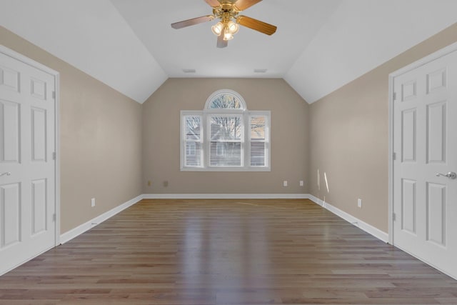 bonus room with ceiling fan, wood finished floors, visible vents, baseboards, and vaulted ceiling