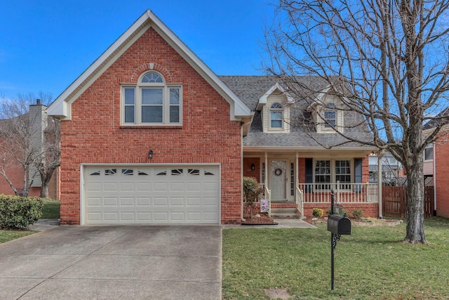 traditional-style home with covered porch, driveway, brick siding, and a front yard