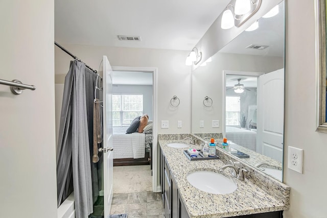 full bathroom with a sink, double vanity, visible vents, and connected bathroom