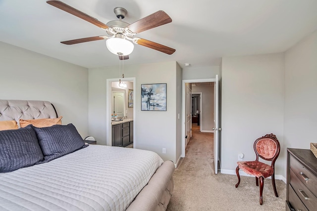 bedroom with light carpet, ceiling fan, baseboards, and connected bathroom