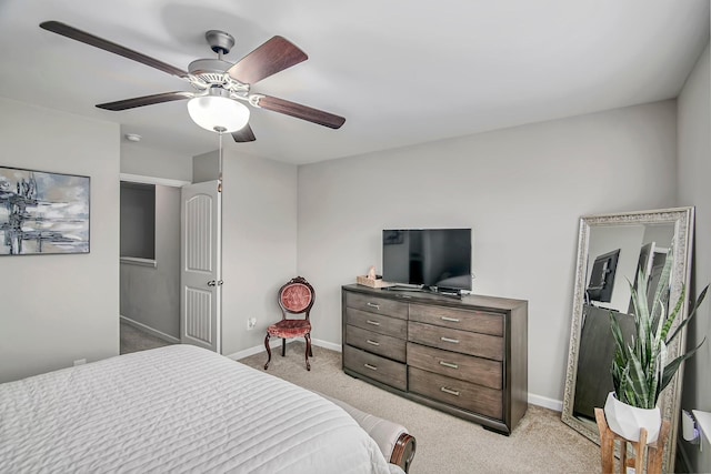 bedroom featuring ceiling fan, baseboards, and light colored carpet