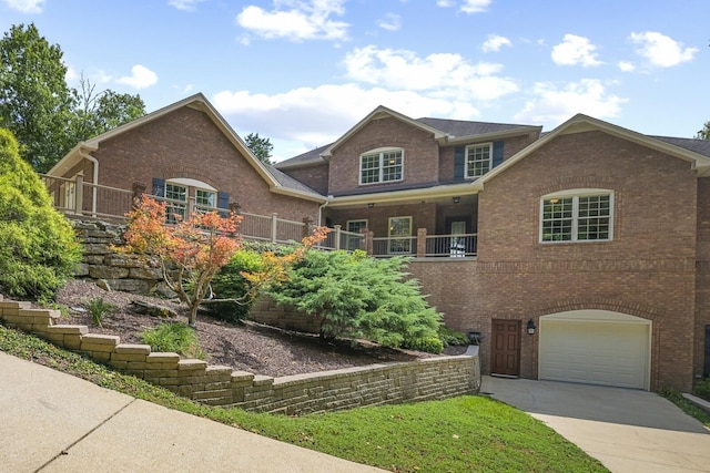 view of front facade featuring concrete driveway, brick siding, and an attached garage