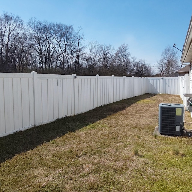 view of yard featuring central AC and a fenced backyard