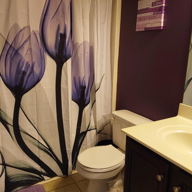 bathroom with toilet, curtained shower, tile patterned flooring, and vanity