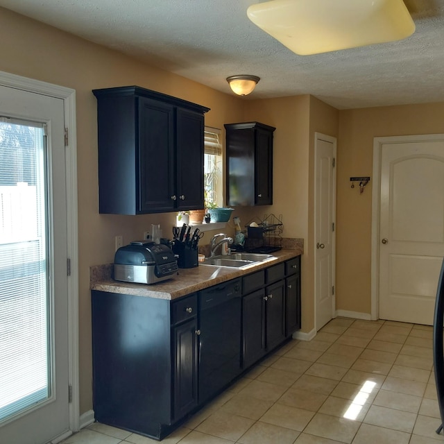 kitchen featuring a wealth of natural light, black dishwasher, light tile patterned floors, and a sink