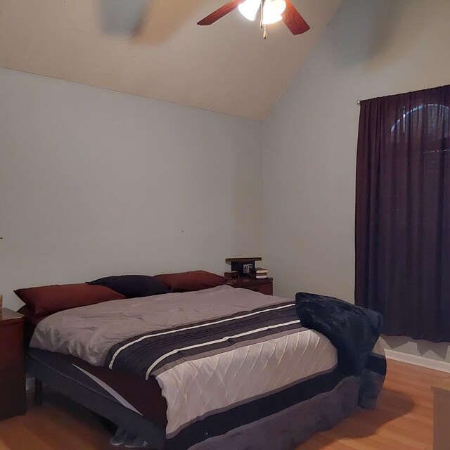 bedroom featuring vaulted ceiling, ceiling fan, and wood finished floors