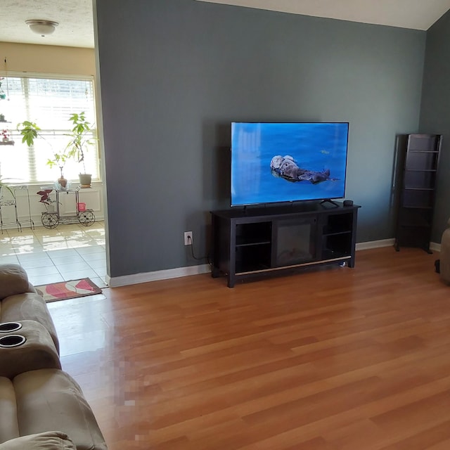 living room with wood finished floors and baseboards