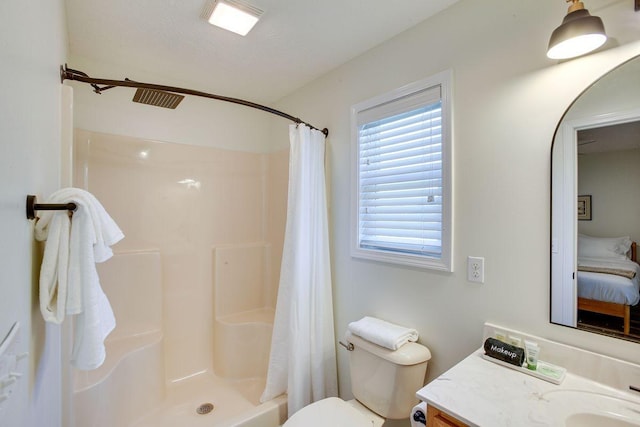 bathroom with toilet, a shower with shower curtain, vanity, and ensuite bathroom