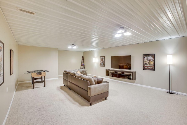 carpeted living room with visible vents and baseboards