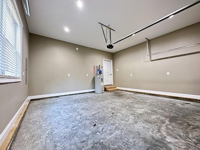 garage with electric water heater and baseboards