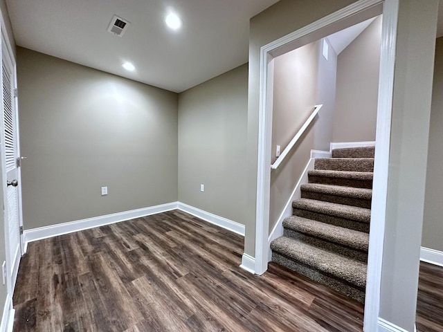 interior space with recessed lighting, dark wood-type flooring, visible vents, baseboards, and stairs