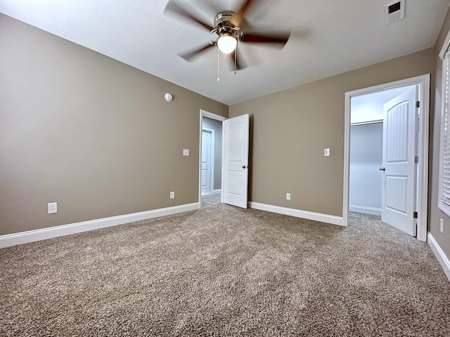 unfurnished bedroom with a ceiling fan, carpet, visible vents, and baseboards