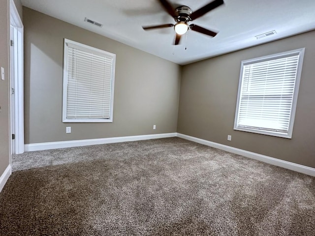 unfurnished room with carpet and visible vents